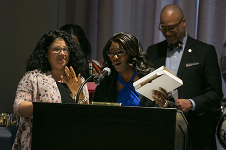 A woman speaking at a podium