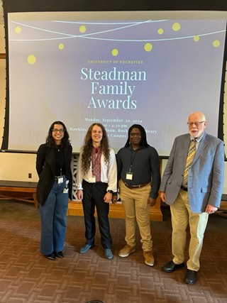Three students and Dr. Steadman pose for a picture.