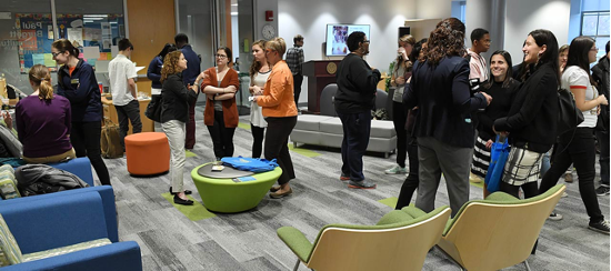 A group of people milling about a room.