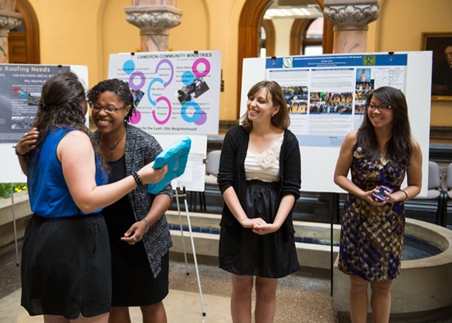 Students presenting their findings at a poster session.