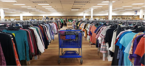 A view of an aisle in a thrift store.