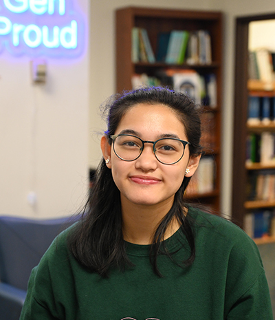 Emily DeVeyra smiling at the camera.