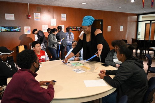 Assistant Director Jerri-Ann Cadet prepares an activity for students participating in the Kearns Center Upward Bound summer program, June 2023.