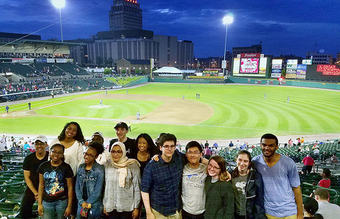 Undergraduate students participating in summer research programs run by the University's David T. Kearns Center take a break from their work to enjoy a Red Wings game and see more of downtown Rochester. (University photo / Michael Droel)