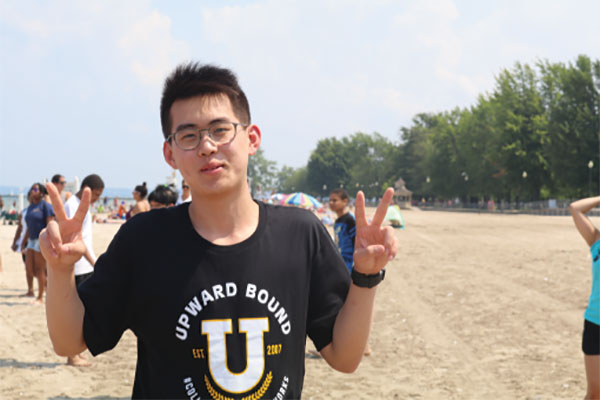 A student posing at the beach.