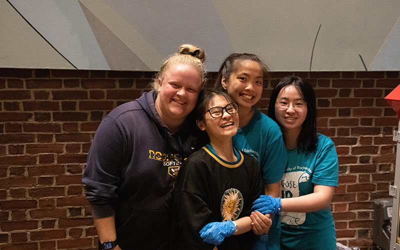 Photo of former orientation team members in front of Morey Hall at Convocation during a previous Welcome Week