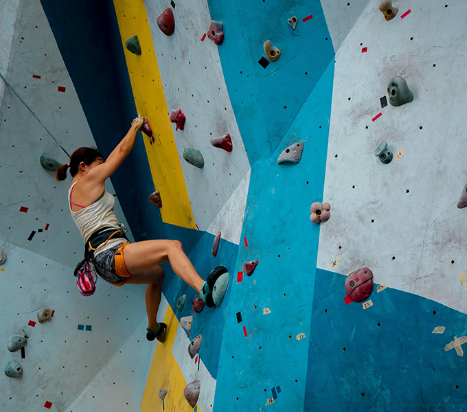 Photo of a woman on a rock climbing wall