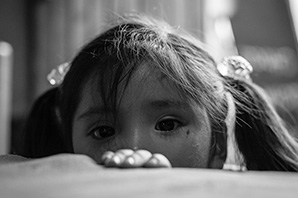 A child peering over a table