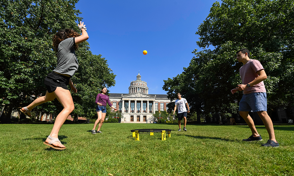 Students play spikeball on the Eastman Quad
