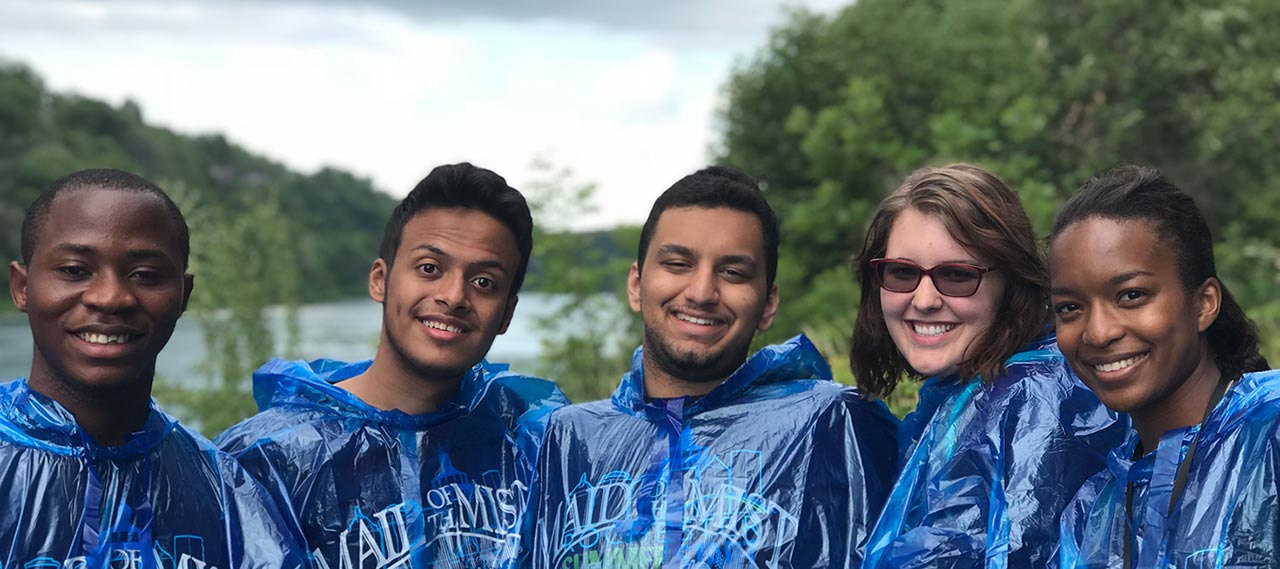 Students pose in Niagara Falls in front of Cave of the Winds.