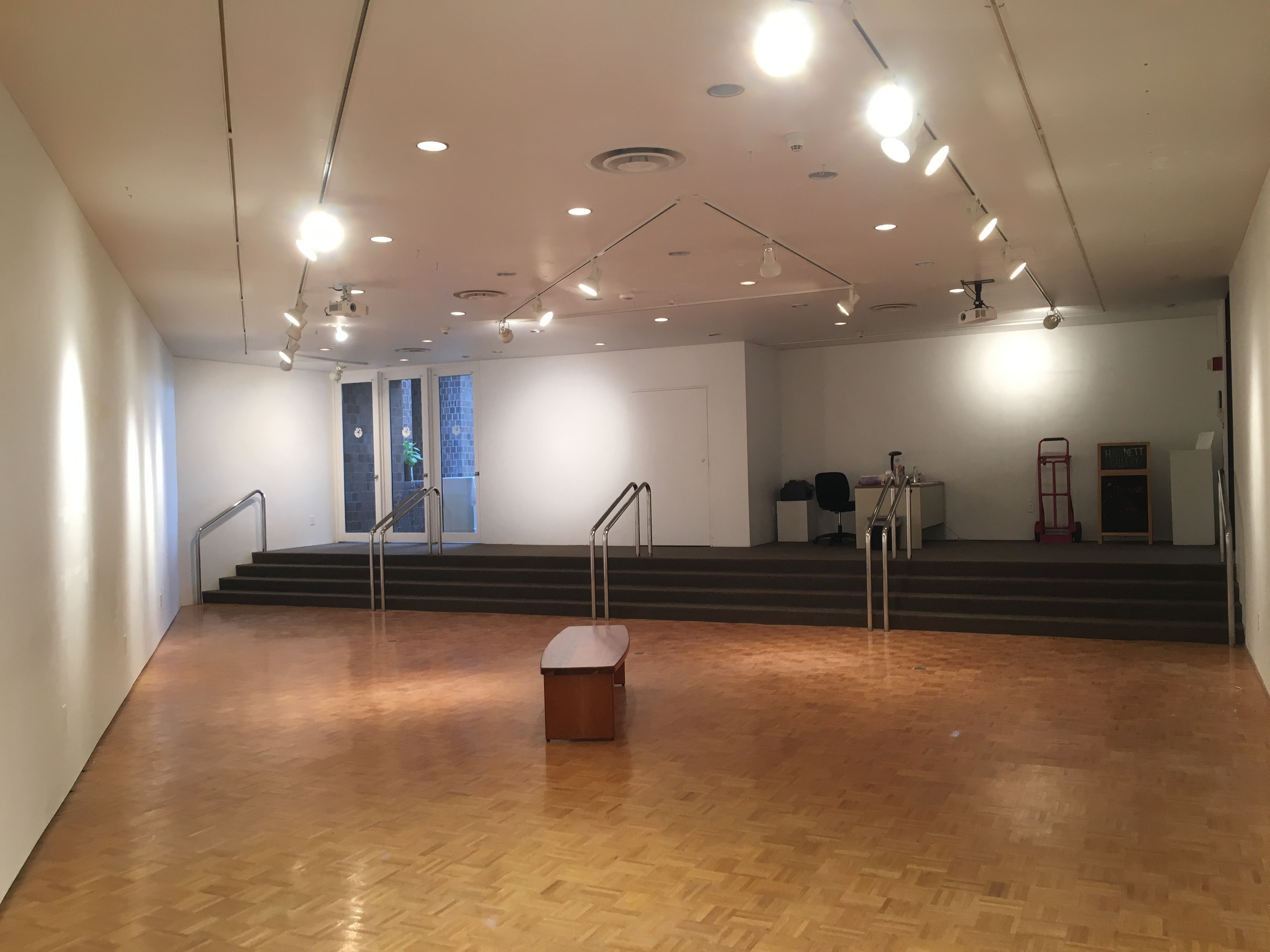 Empty Hartnett gallery with entrance on the right and the side door on the left