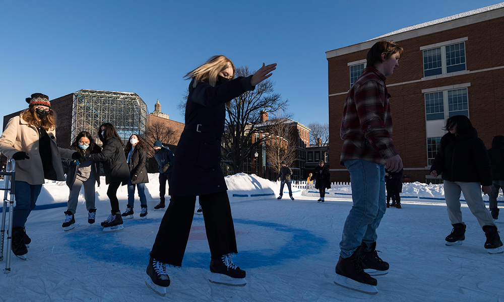Students ice skating on temporary rink built on Wilson Quad on the River Campus
