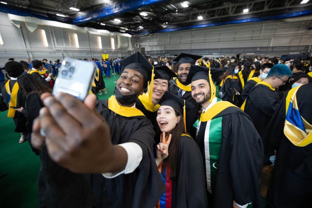 Class of 2022 students celebrating graduation on Rochester's campus.