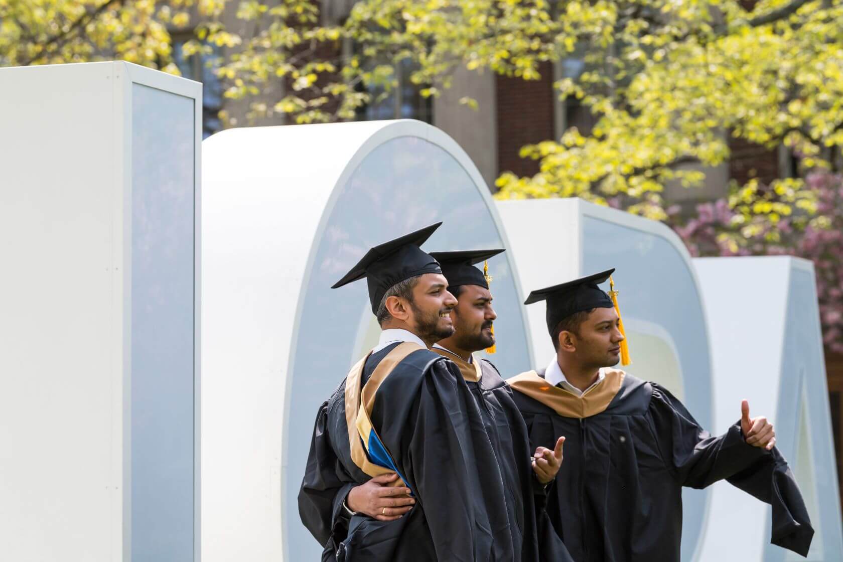 Class of 2022 students celebrating graduation on Rochester's campus.