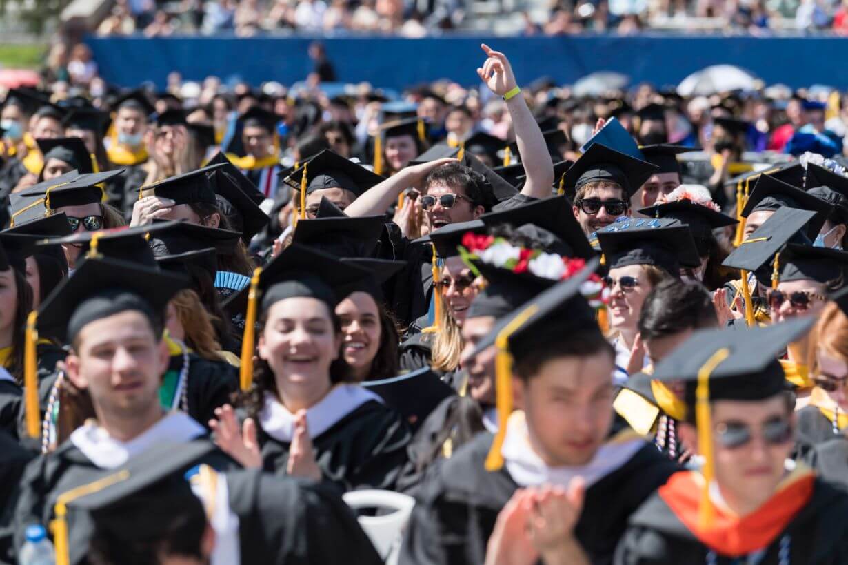 Class of 2022 students celebrating graduation on Rochester's campus.