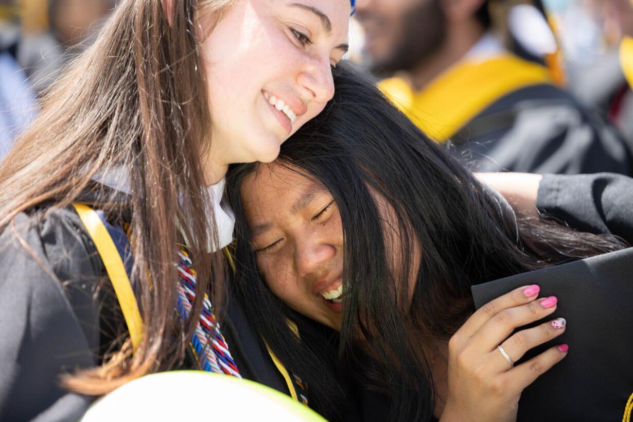 Class of 2022 students celebrating graduation on Rochester's campus.