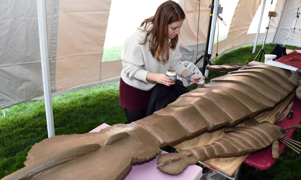 College student touches up with paint a 9-foot-long jaekelopterus model.
