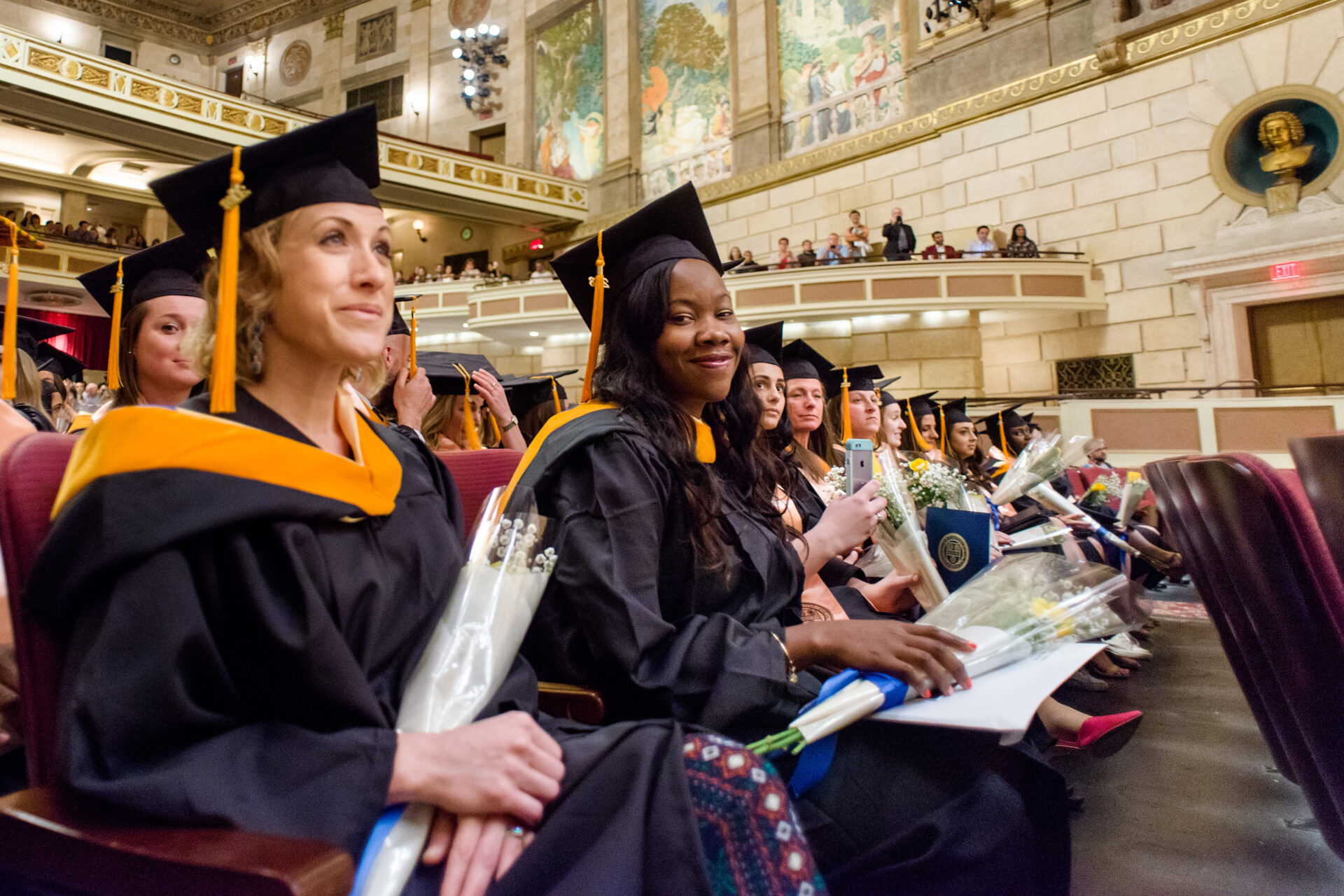 Nursing graduates sitting in the audience at Kodak Hall during a graduation ceremony.