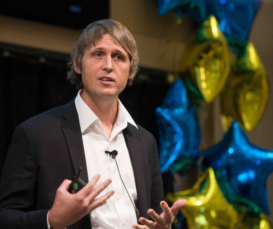 Michael Hassleberg speaking on a stage during Meliora Weekend.