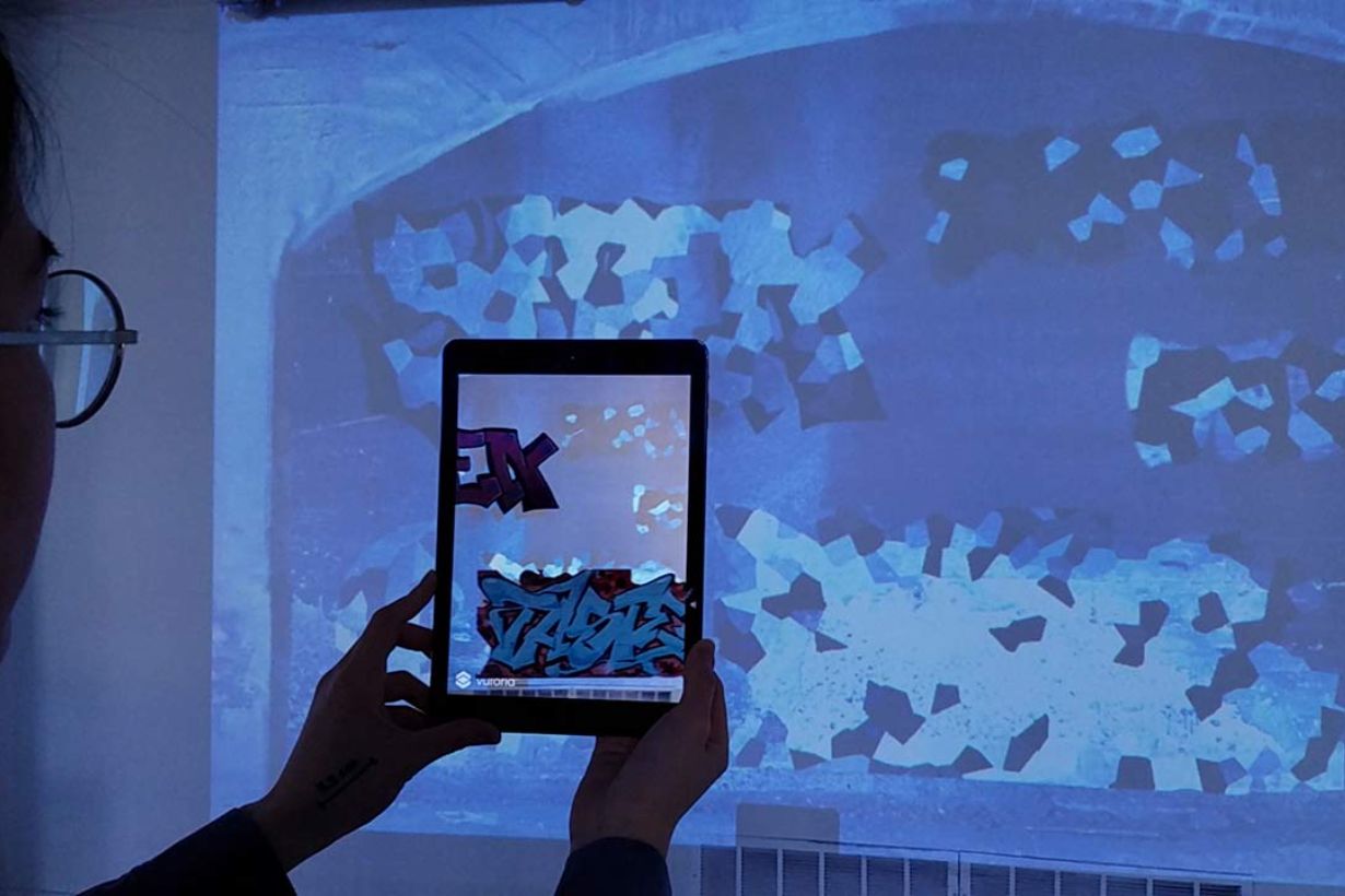 Animated gif showing subway grafitti displayed on an iPad.