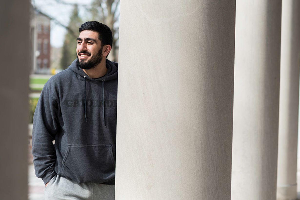 Bobby Gerami leaning against a stone column.