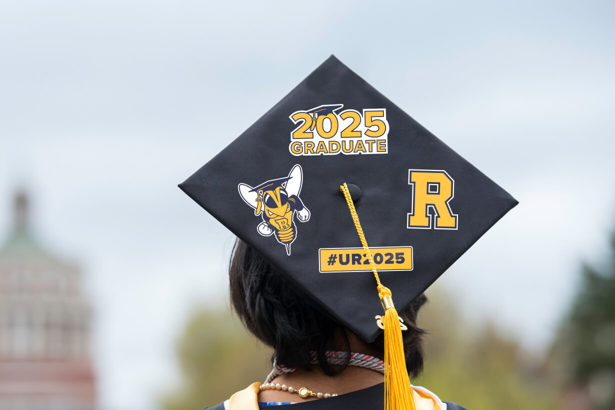 A graduate wearing a cap adorned with the year 2025, symbolizing achievement and academic success.