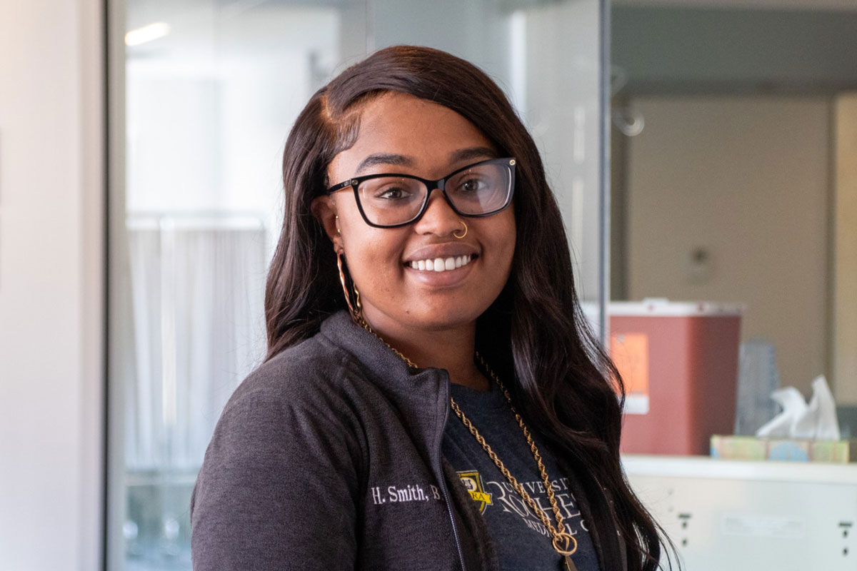 Hylin Smith, a University of Rochester Class of 2025 student, wearing glasses and a black jacket.