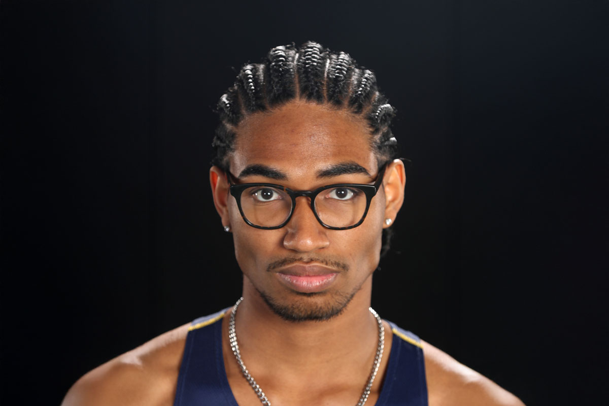 A man with glasses and braids, Cole Goodman, a University of Rochester Class of 2025 student.