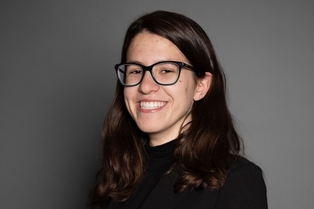 A smiling woman with glasses in a black shirt, Isabella Rocha, a University of Rochester Class of 2025 student.