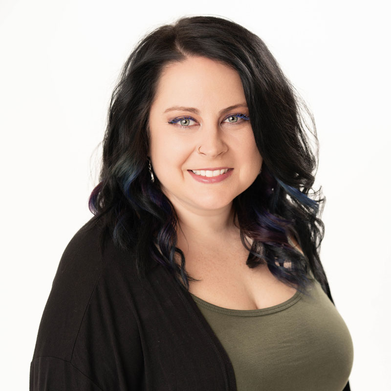 A woman with black hair wearing a black jacket, representing Kelly Looymans, an ASL instructor at Twinsburg High School.