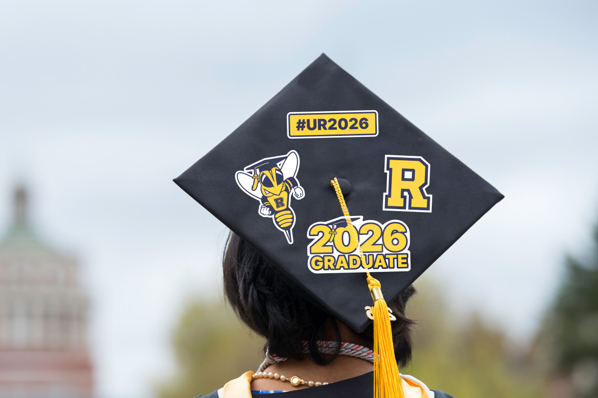 person wearing a black and yellow graduation cap, celebrating Commencement 2026.
