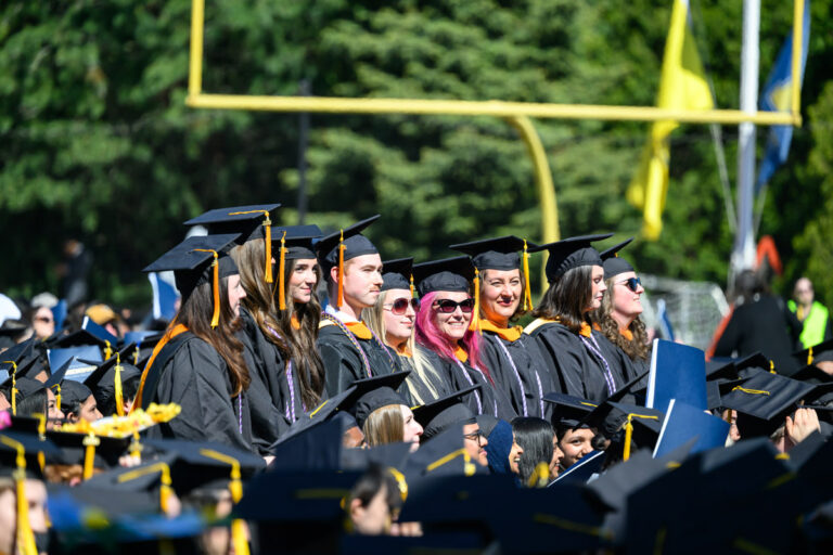 University of Rochester graduates stand together during the Commencement Weekend ceremony.