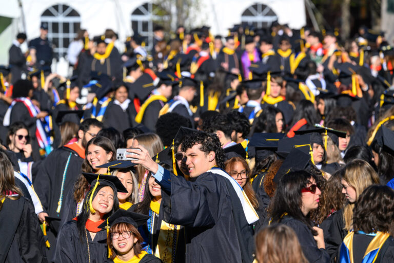 A crowd of University of Rochester graduates gathers on campus during Commencement Weekend.