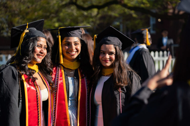 Three University of Rochester graduates pose for a photo during Commencement Weekend.