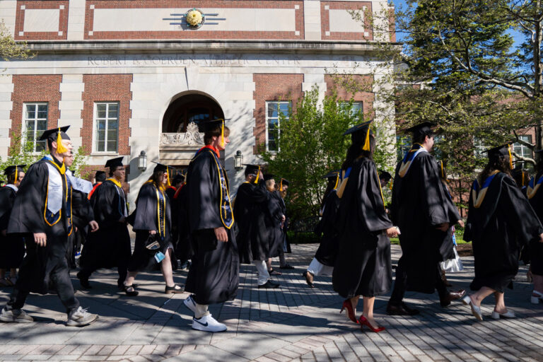 University of Rochester graduates walk past the Robert B. Goergen Athletic Center during Commencement Weekend.