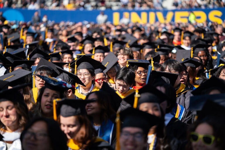 A large crowd of University of Rochester graduates fills Fauver Stadium during the Commencement Weekend ceremony.