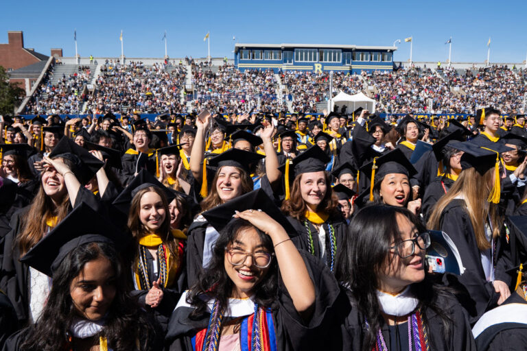 University of Rochester graduates cheer and clap during the Commencement Weekend ceremony.