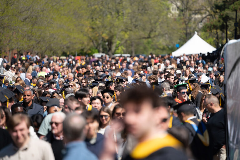 University of Rochester graduates wave and smile from the crowd during Commencement Weekend.