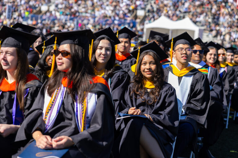 University of Rochester graduates sit among the crowd during the Commencement Weekend ceremony.