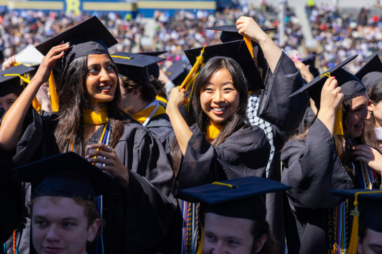 University of Rochester graduates adjust their caps during the Commencement Weekend ceremony.