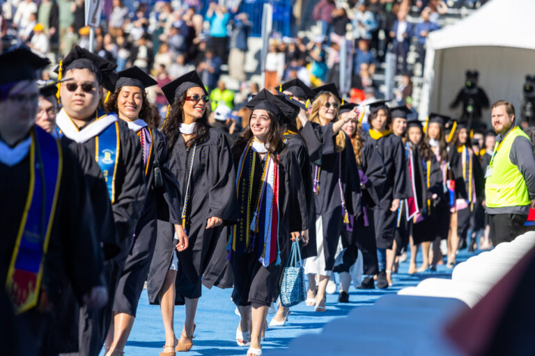 University of Rochester graduates process down the blue carpet during Commencement Weekend.