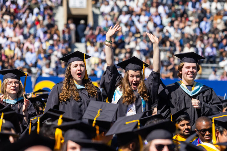 University of Rochester graduates wave, clap, and cheer during the Commencement Weekend ceremony.