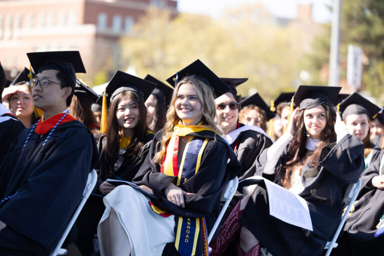 University of Rochester graduates sit together during the Commencement Weekend ceremony.