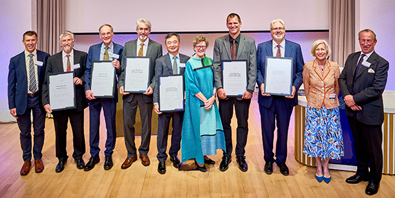 Winners of the Rank Prize hold their official placards during a special ceremony in London.