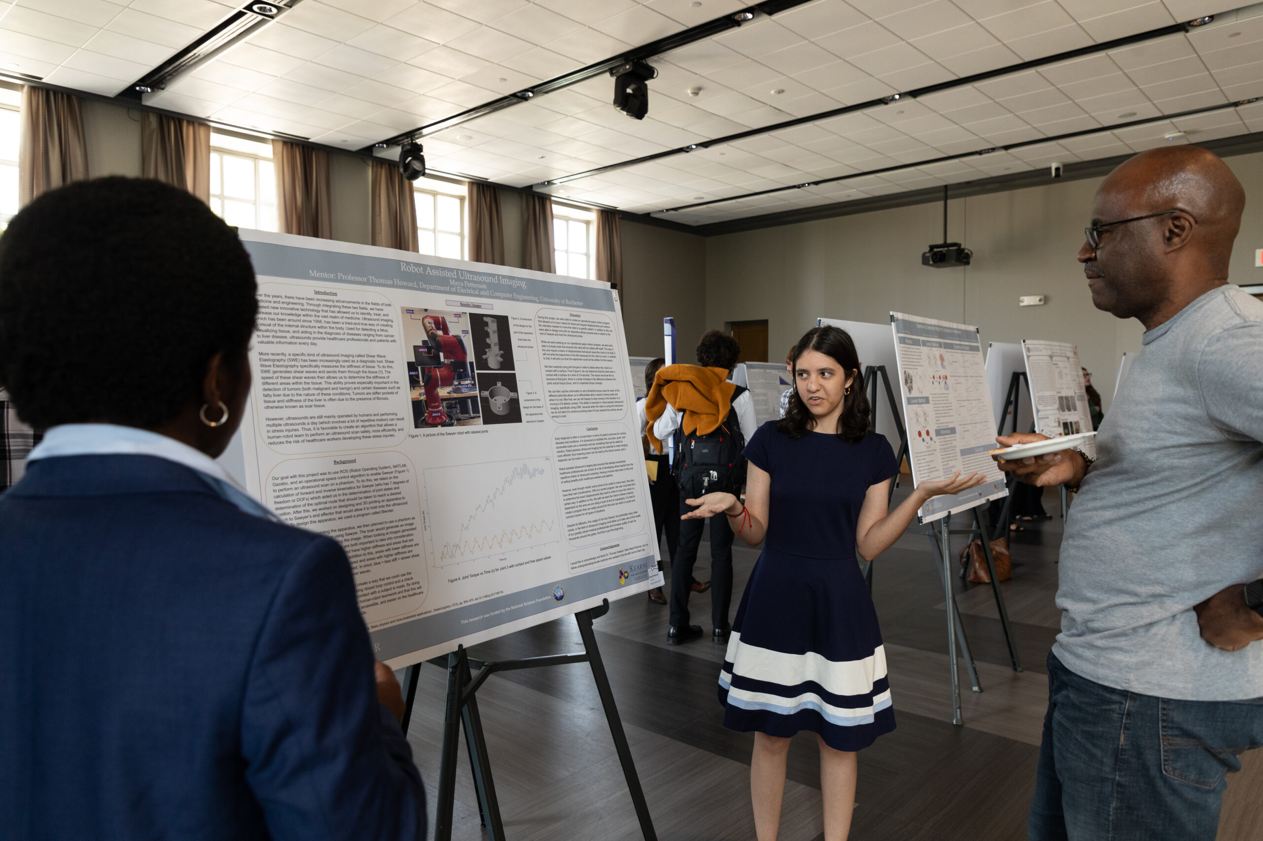 A student explains her research during a poster session at the Feldman Ballroom.
