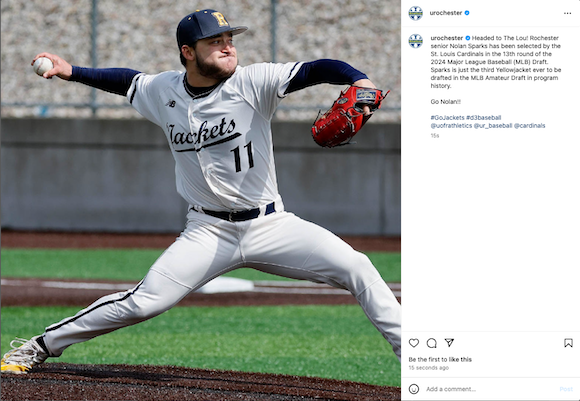 Pitcher Nolan Sparks, wearing his Rochester uniform, pitching from the mound.