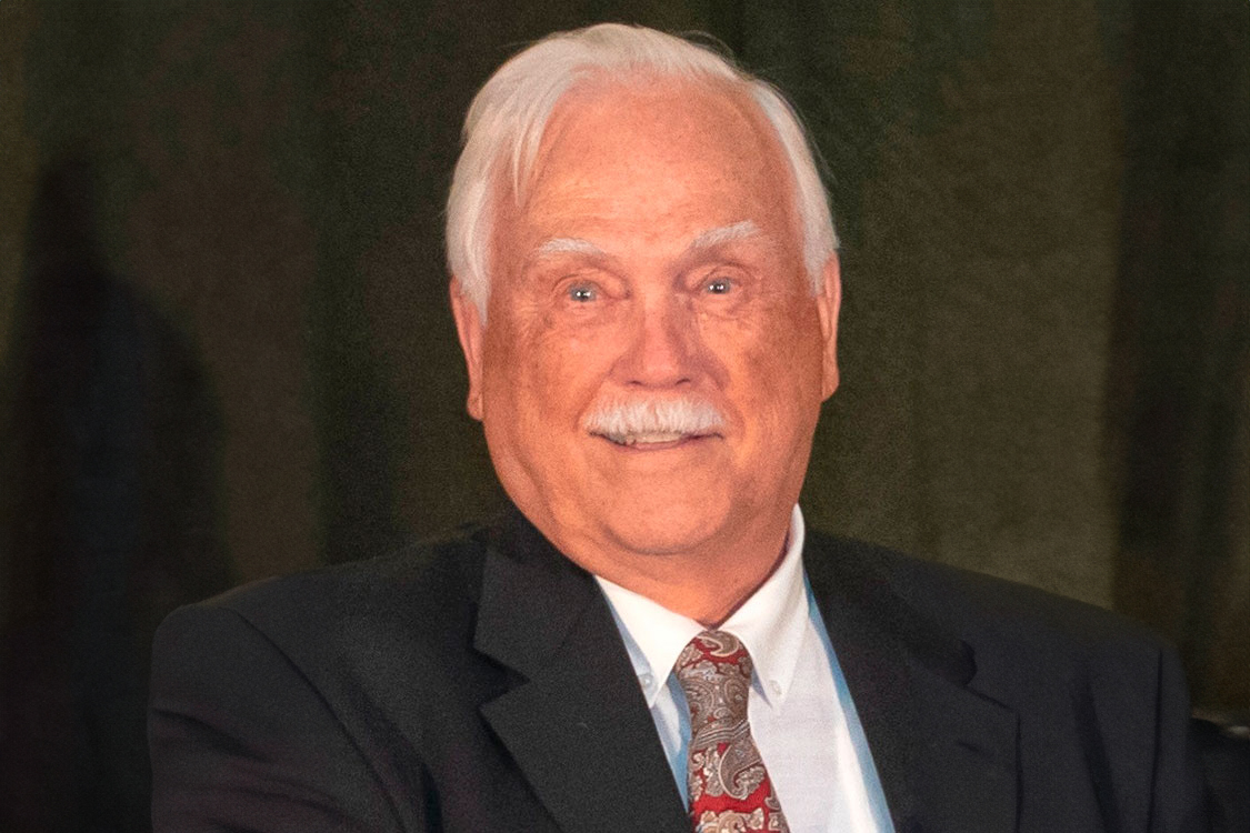 A headshot of Bill Krupke wearing a suit and tie.