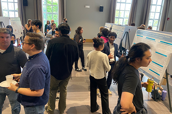 Students present their research on posters in the Feldman Ballroom.