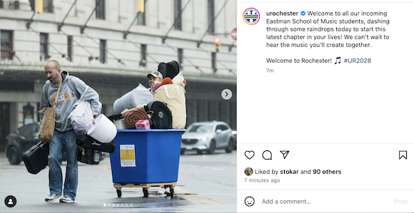 Student pulls cart full of college items across the street with parent 