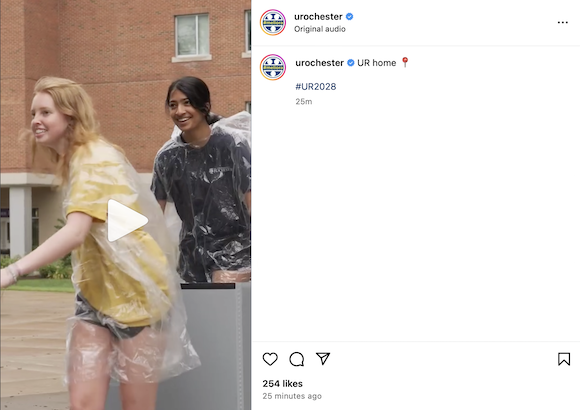 Screenshot of the University of Rochester Instagram with two students in rain ponchos during Move-In Day